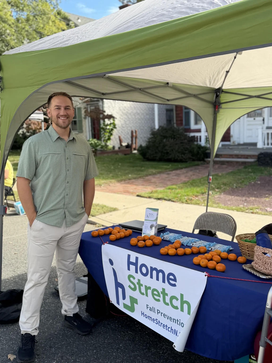 George beside the Home Stretch information table at a community event