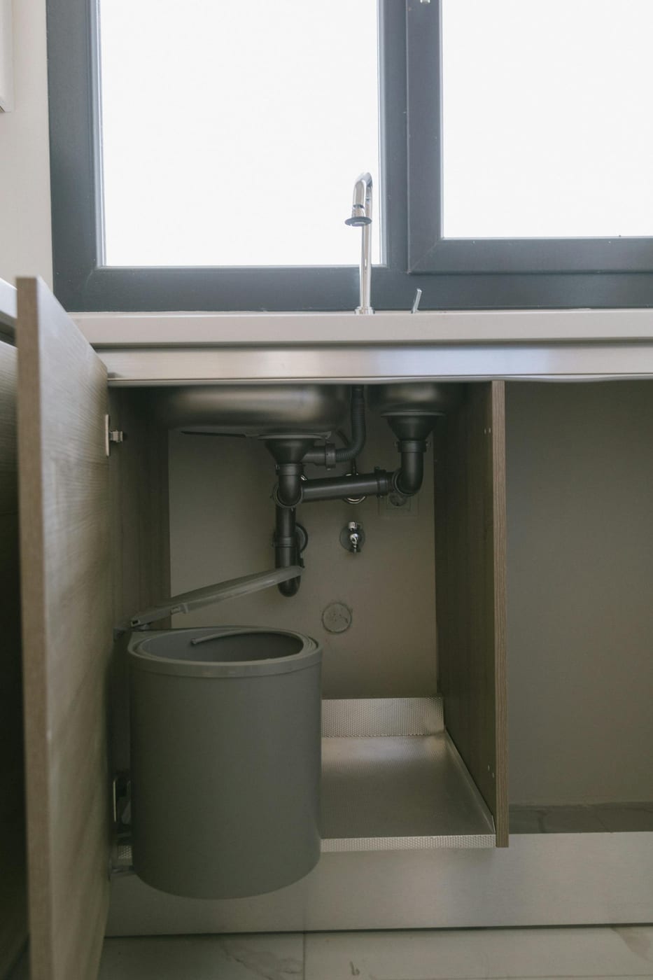 Residential plumbing under a kitchen sink