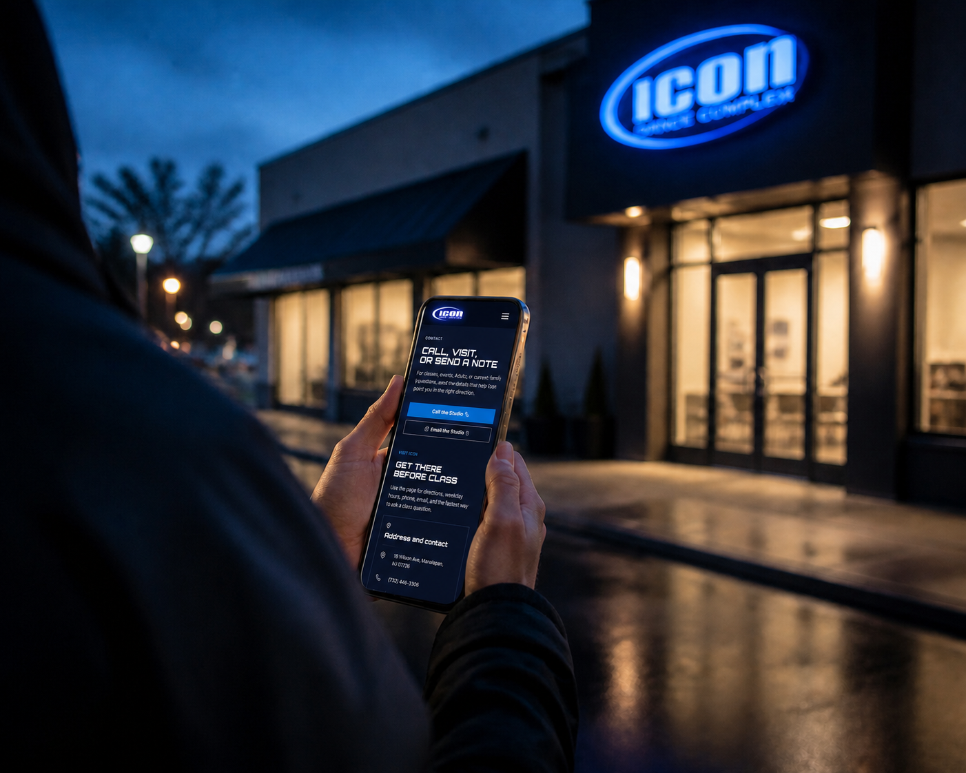 Icon Dance Complex contact page shown on a phone outside the studio